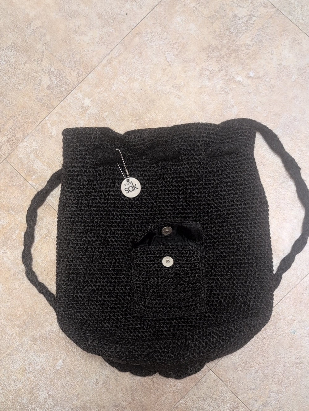The Sak Black Crochet Shoulder Bag with Front Pocket and Charm
